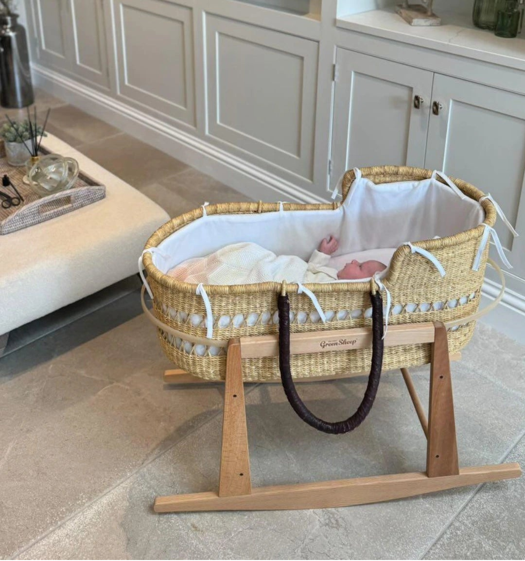 Baby in Handmade Ghanaian Moses basket with traditional woven design